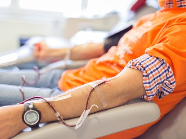 Blood donor at donation with a bouncy ball holding in hand.